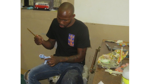 A craftsman finishes an elephant candle